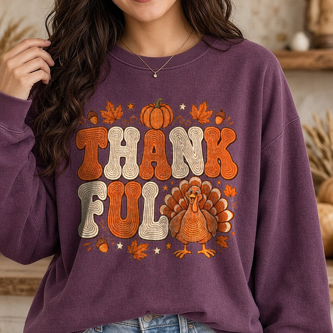 Thankful Turkey Orange Groovy Letters Leaves DTF transfer shown on a Comfort Colors sweatshirt