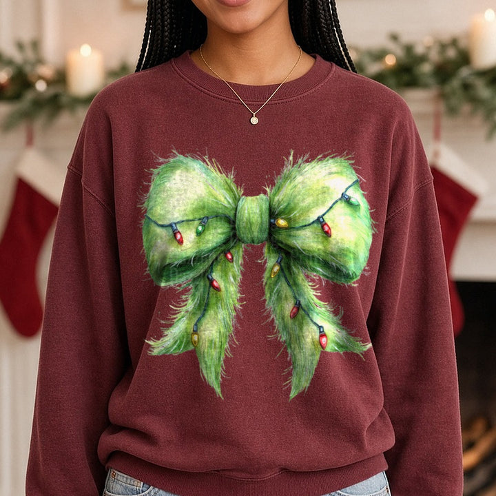 Grinch Bow DTF transfer shown on a Comfort Colors sweatshirt