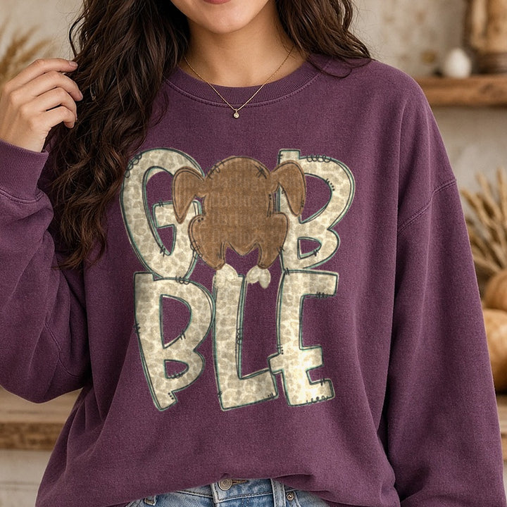 Gobble Leopard Print Letters Roasted Turkey Thanksgiving DTF transfer shown on a Comfort Colors sweatshirt