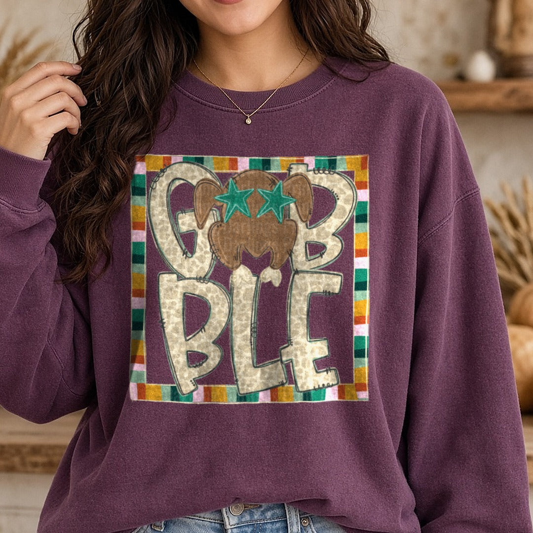 Gobble Leopard Print Letters Thanksgiving Turkey Teal Stars DTF transfer shown on a Comfort Colors sweatshirt