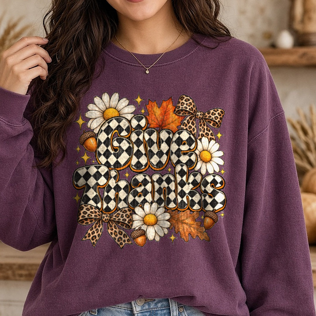 Checkered Give Thanks Black White Daisies Leopard Bows DTF transfer shown on a Comfort Colors sweatshirt