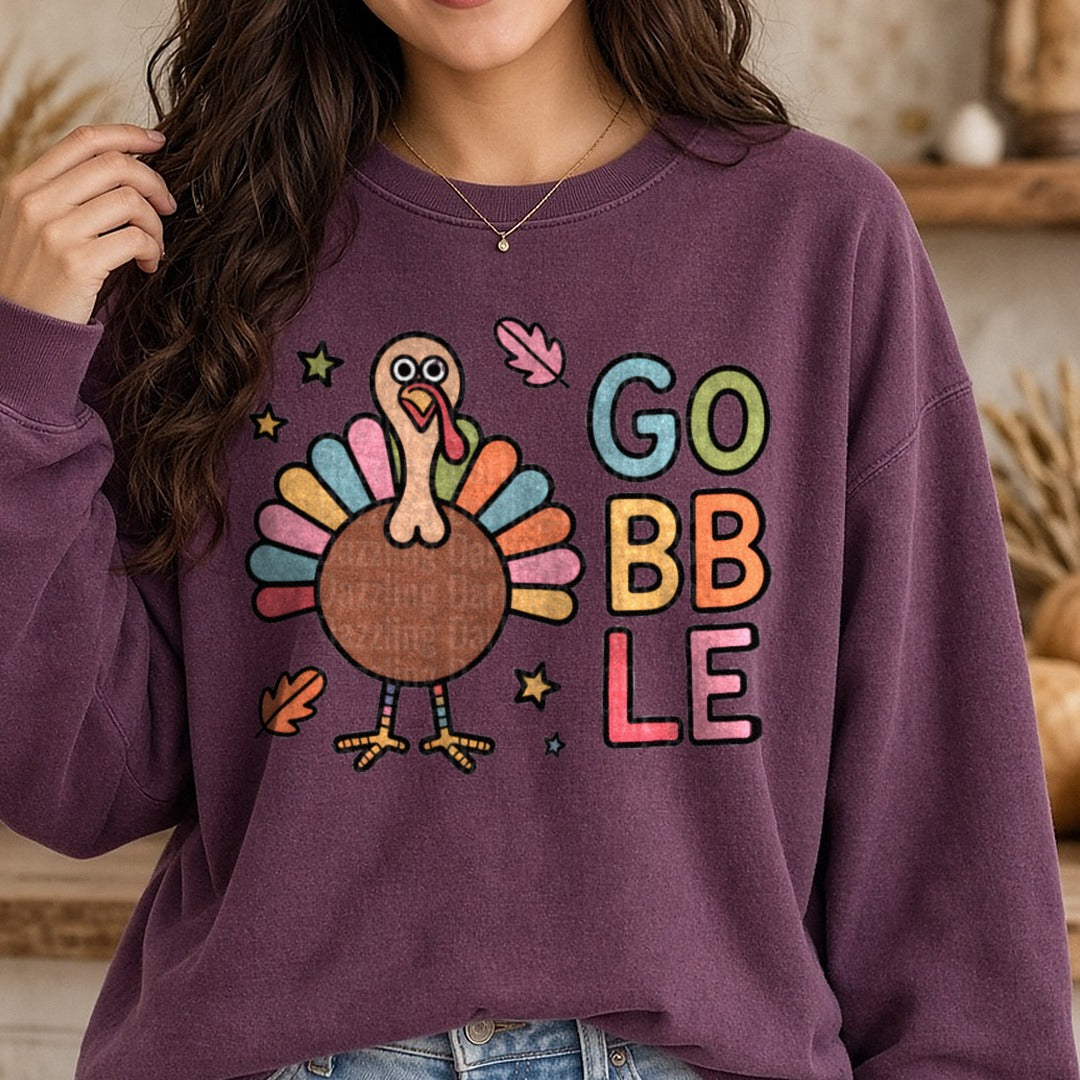Colorful Gobble Turkey Thanksgiving DTF transfer shown on a Comfort Colors sweatshirt