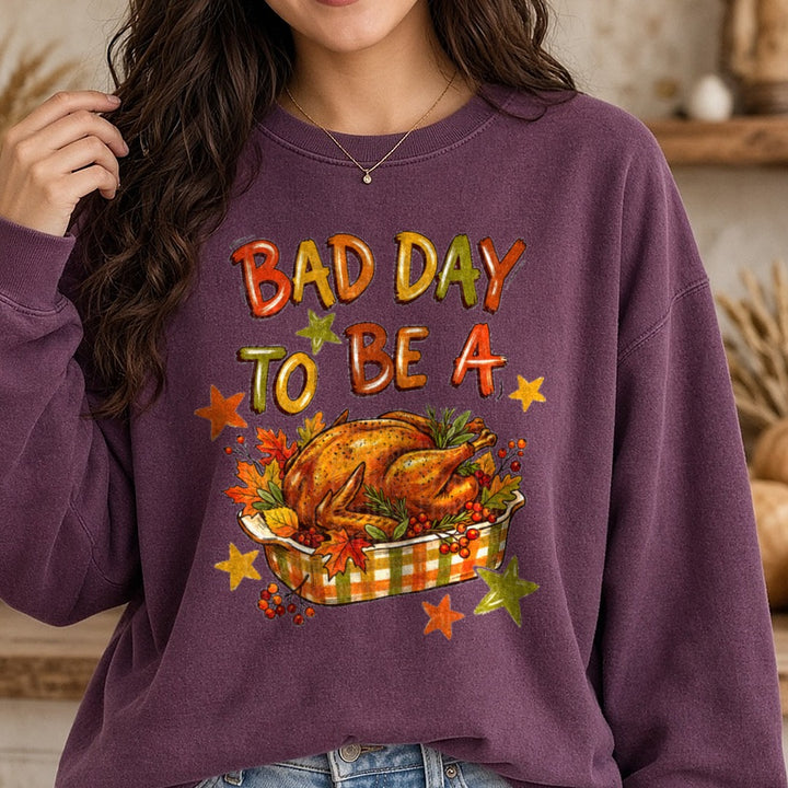 Bad Day to be a Turkey Roasted Turkey Platter Fall Leaves DTF transfer shown on a Comfort Colors sweatshirt