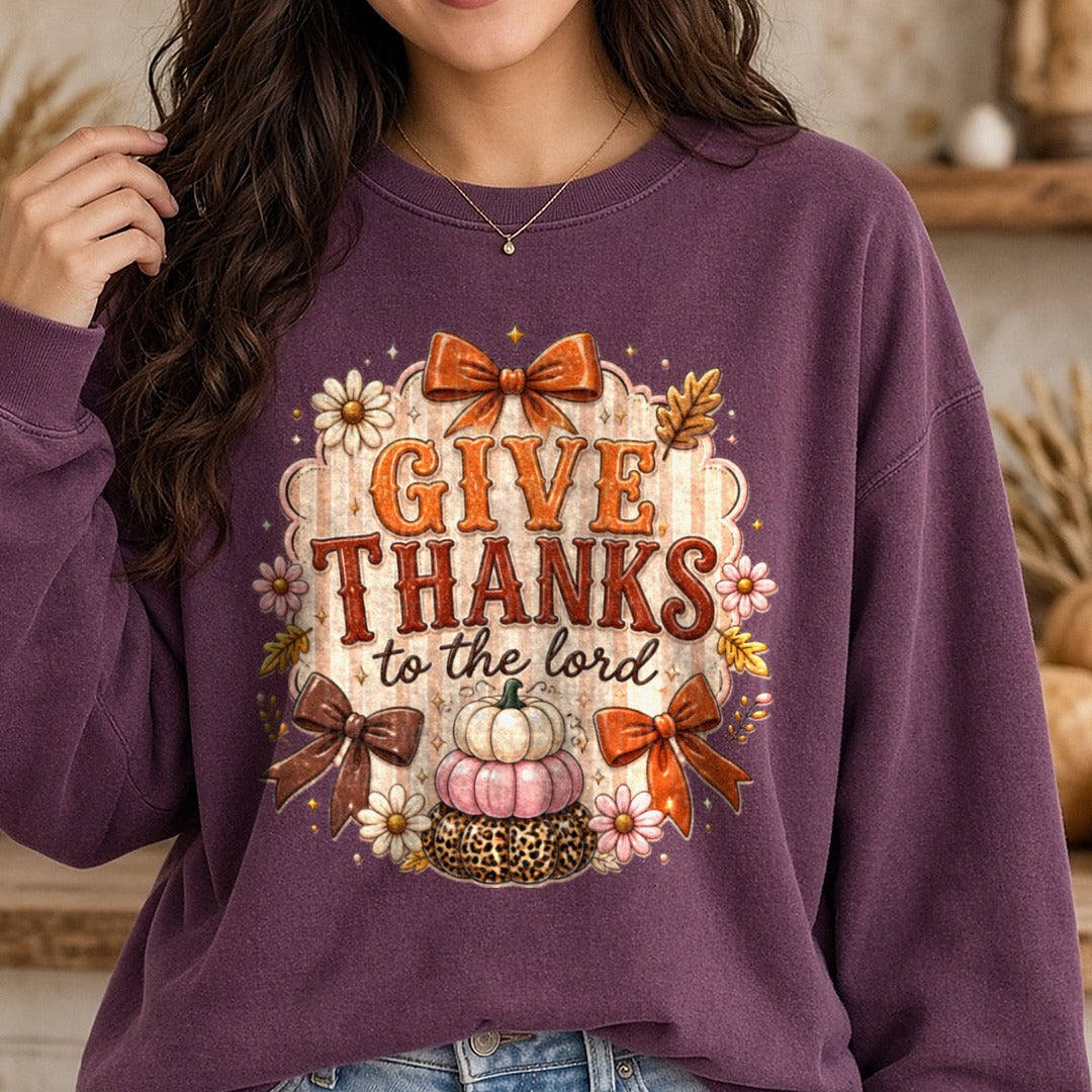 Give Thanks To The Lord Leopard Pumpkins Orange Bows DTF transfer shown on a Comfort Colors sweatshirt