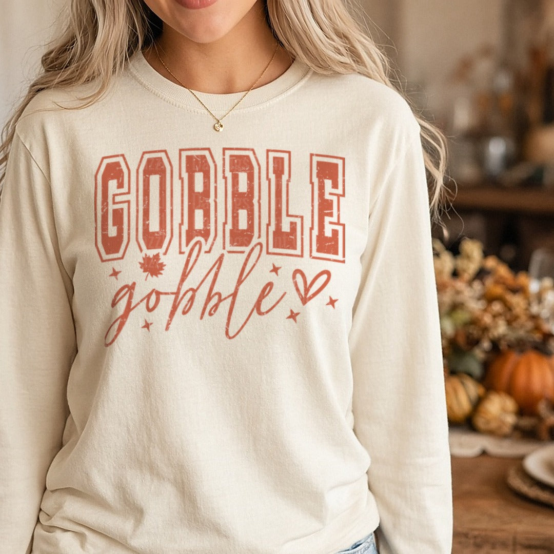 Distressed Gobble Gobble Rust Varsity Letters Script DTF transfer shown on a Comfort Colors long sleeve tee