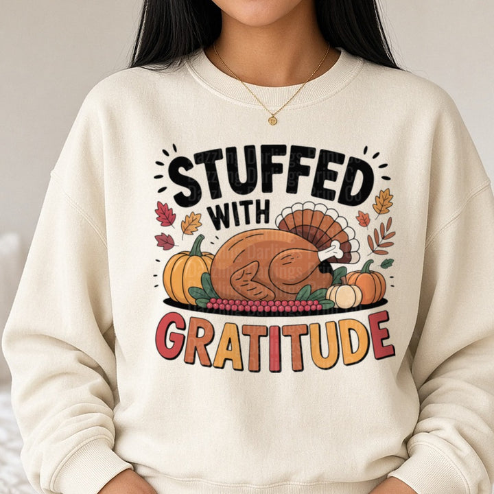 Stuffed With Gratitude Black Letters Turkey Pumpkins DTF transfer shown on a Comfort Colors sweatshirt
