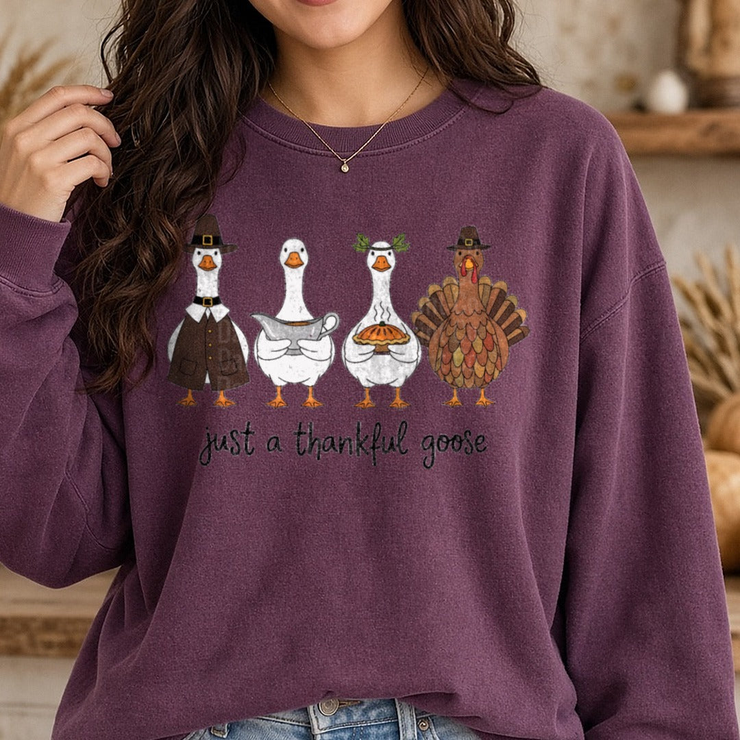 Just A Thankful Goose Pilgrim Geese Turkey Gravy Boat DTF transfer shown on a Comfort Colors sweatshirt