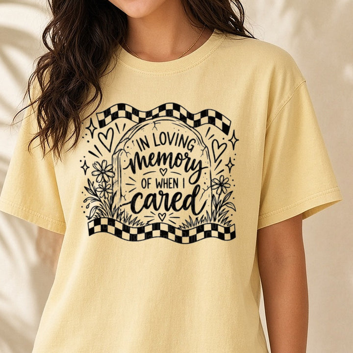 In Loving Memory Of When I Cared Tombstone Checkered DTF transfer shown on a Comfort Colors tee