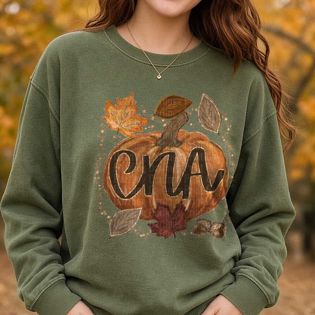 CNA Fall Pumpkin with Autumn Leaves and Acorns DTF transfer shown on a Comfort Colors sweatshirt