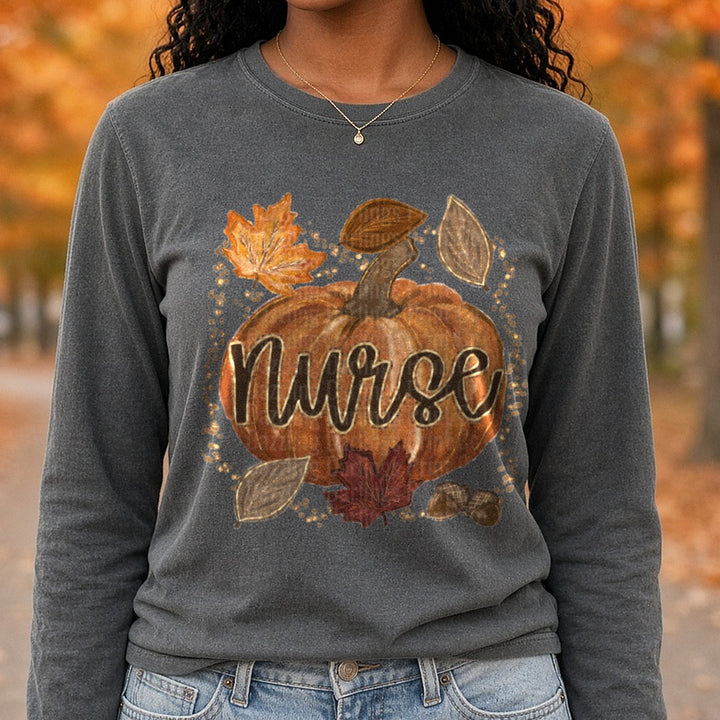 Fall Pumpkin Nurse Script with Autumn Leaves and Acorns DTF transfer shown on a Comfort Colors long sleeve tee
