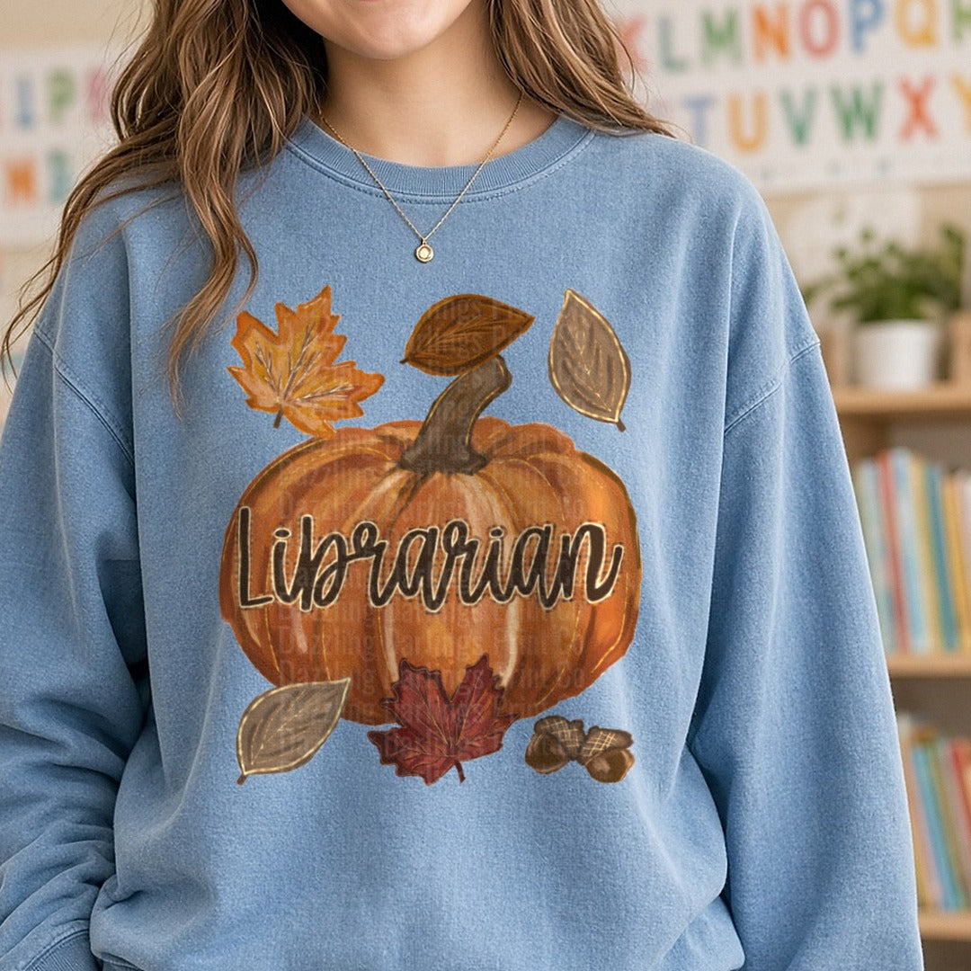 Fall Pumpkin Librarian Script with Autumn Leaves and Acorns DTF transfer shown on a Comfort Colors sweatshirt