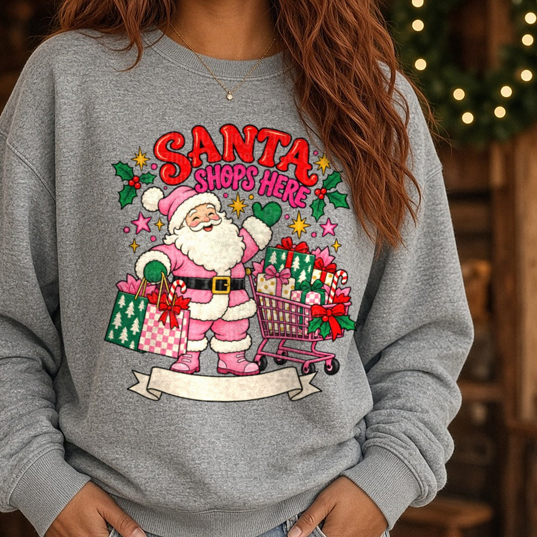 Santa Shops Here Pink Santa With Cart and Gift Bags DTF transfer shown on a Comfort Colors sweatshirt