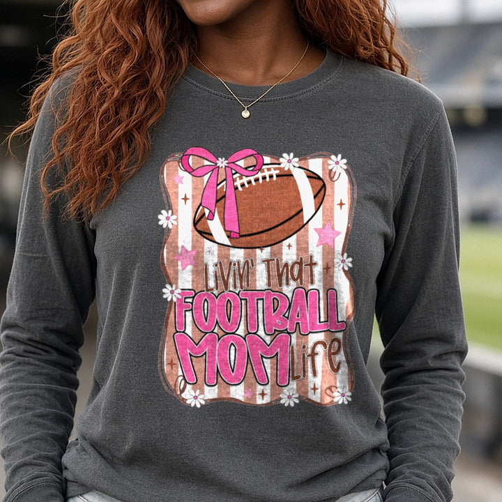 Livin' That Football Mom Life DTF transfer shown on a Comfort Colors long sleeve tee