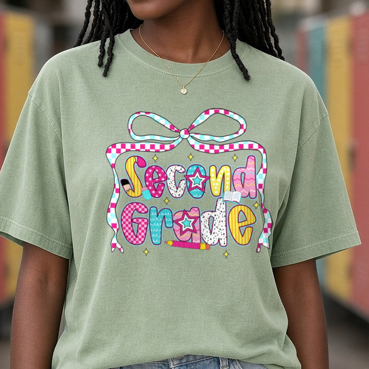Back To School Second Grade Checkered Ribbon Bow Patterned Letters DTF transfer shown on a Comfort Colors tee