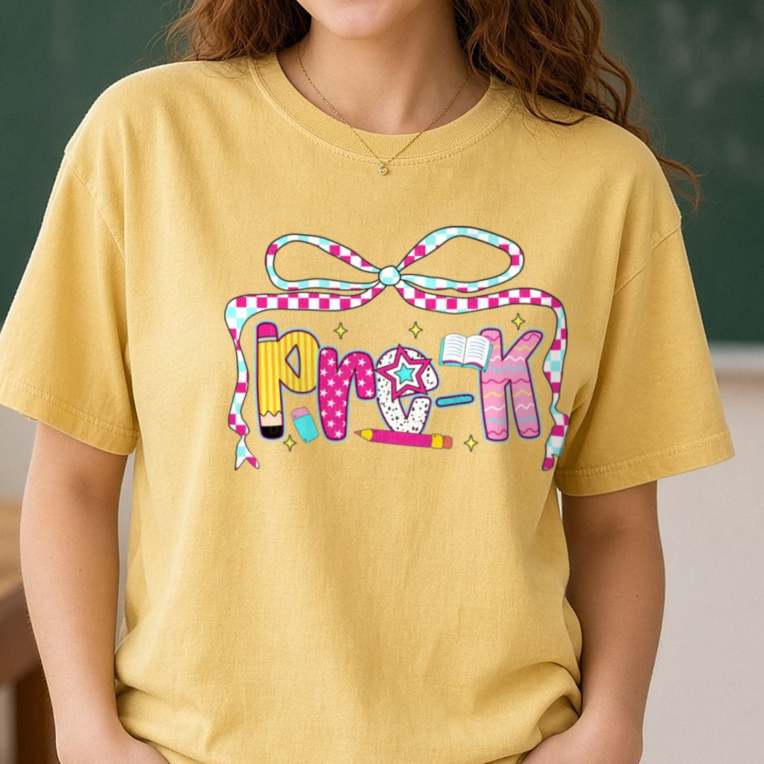 Back To School Pre-K Checkered Ribbon Bow Patterned Letters DTF transfer shown on a Comfort Colors tee