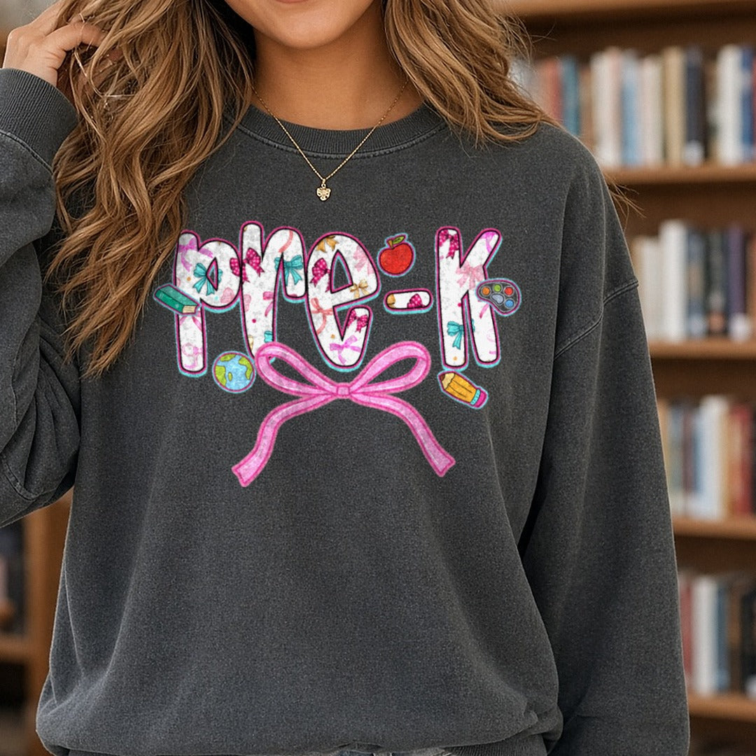Back To School Pre-K Floral Letters Pink Bow Apple DTF transfer shown on a Comfort Colors sweatshirt