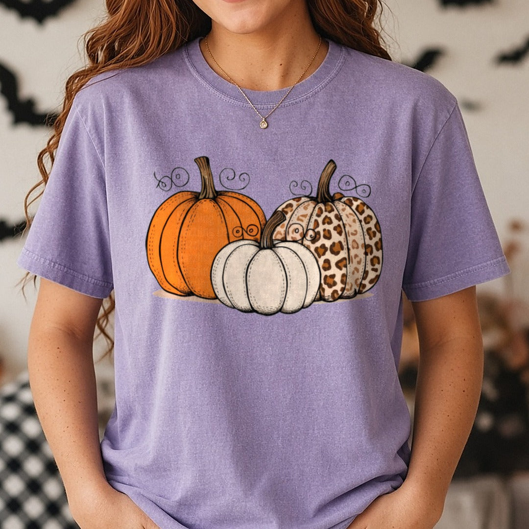Halloween Fall Pumpkin Orange Cream Leopard Swirl Trio DTF transfer shown on a Comfort Colors tee