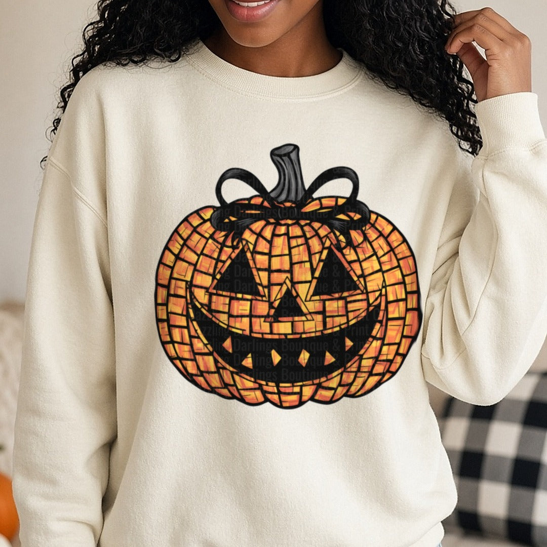 Halloween Fall Pumpkin Mosaic Jack O Lantern Black Bow DTF transfer shown on a Comfort Colors sweatshirt