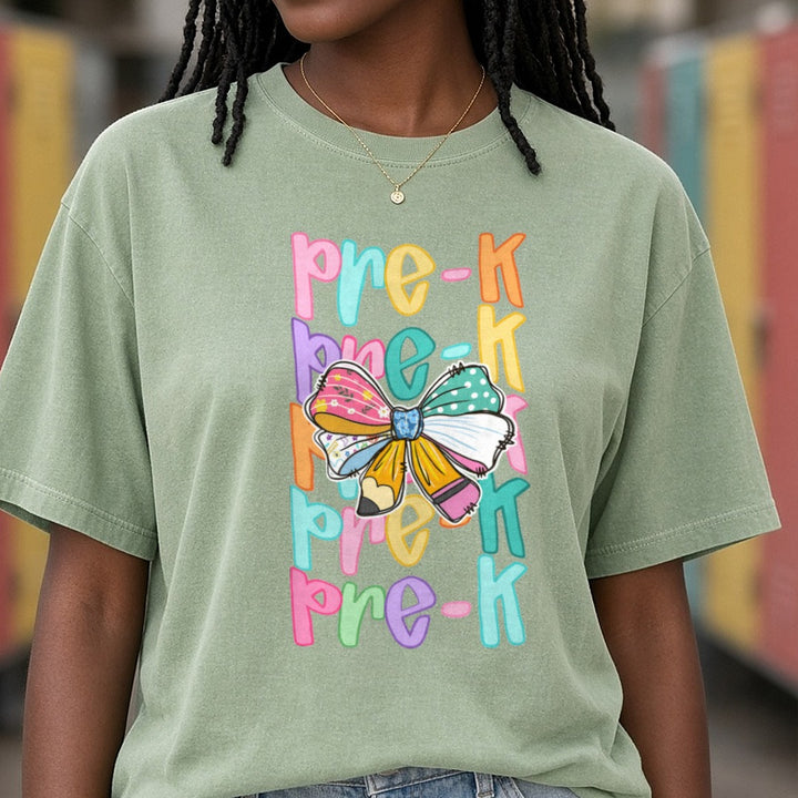 Back To School Teacher Pre-K Rainbow Repeat Text Pencil Bow DTF transfer shown on a Comfort Colors tee