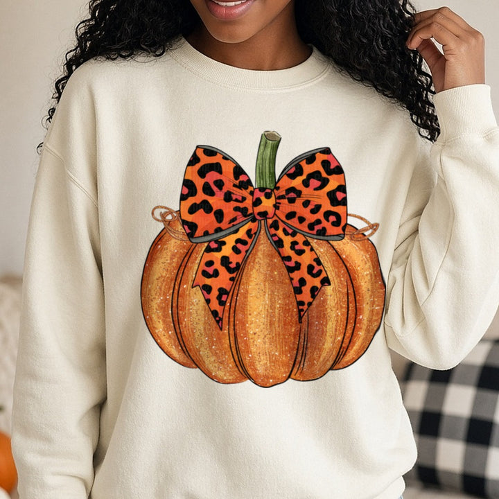 Halloween Fall Pumpkin Leopard Coquette Bow DTF transfer shown on a Comfort Colors sweatshirt
