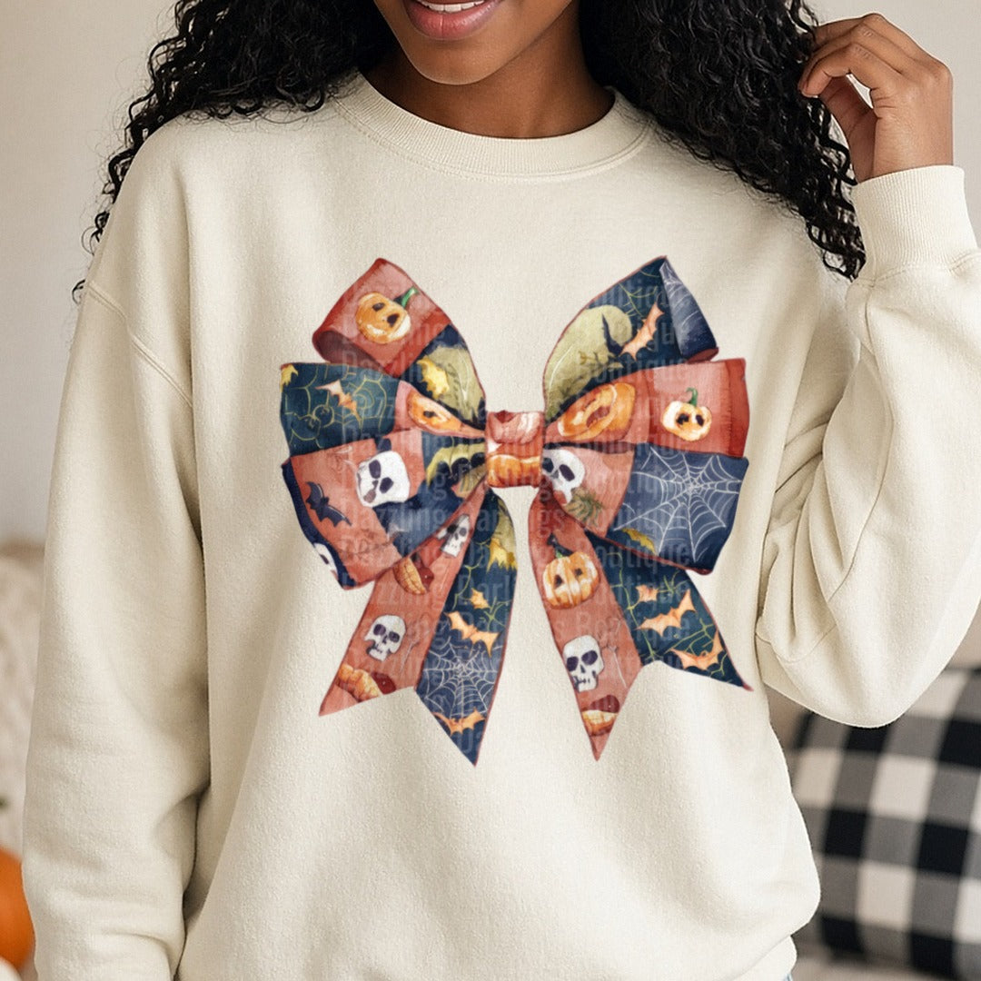 Halloween Fall Coquette Bow Rust Navy Jack O Lantern Bats DTF transfer shown on a Comfort Colors sweatshirt