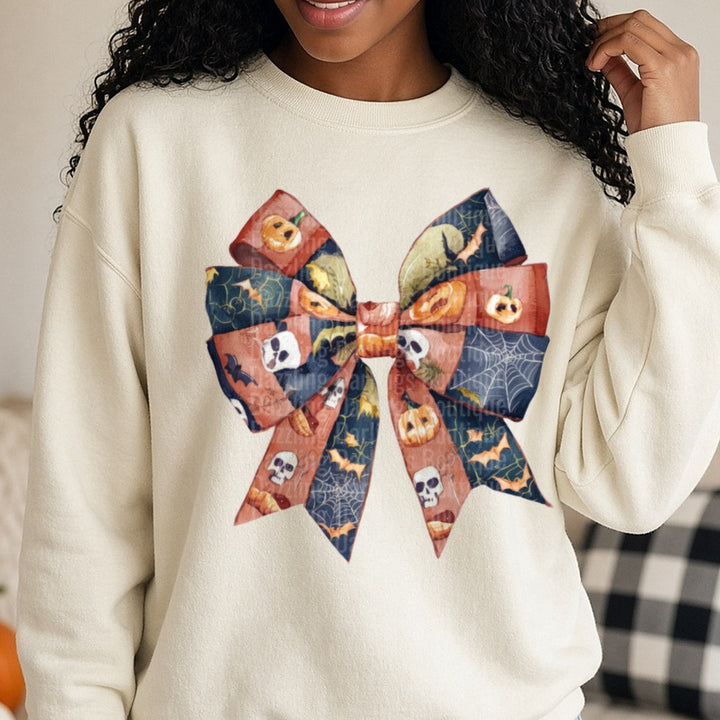 Halloween Fall Coquette Bow Rust Navy Jack O Lantern Bats DTF transfer shown on a Comfort Colors sweatshirt
