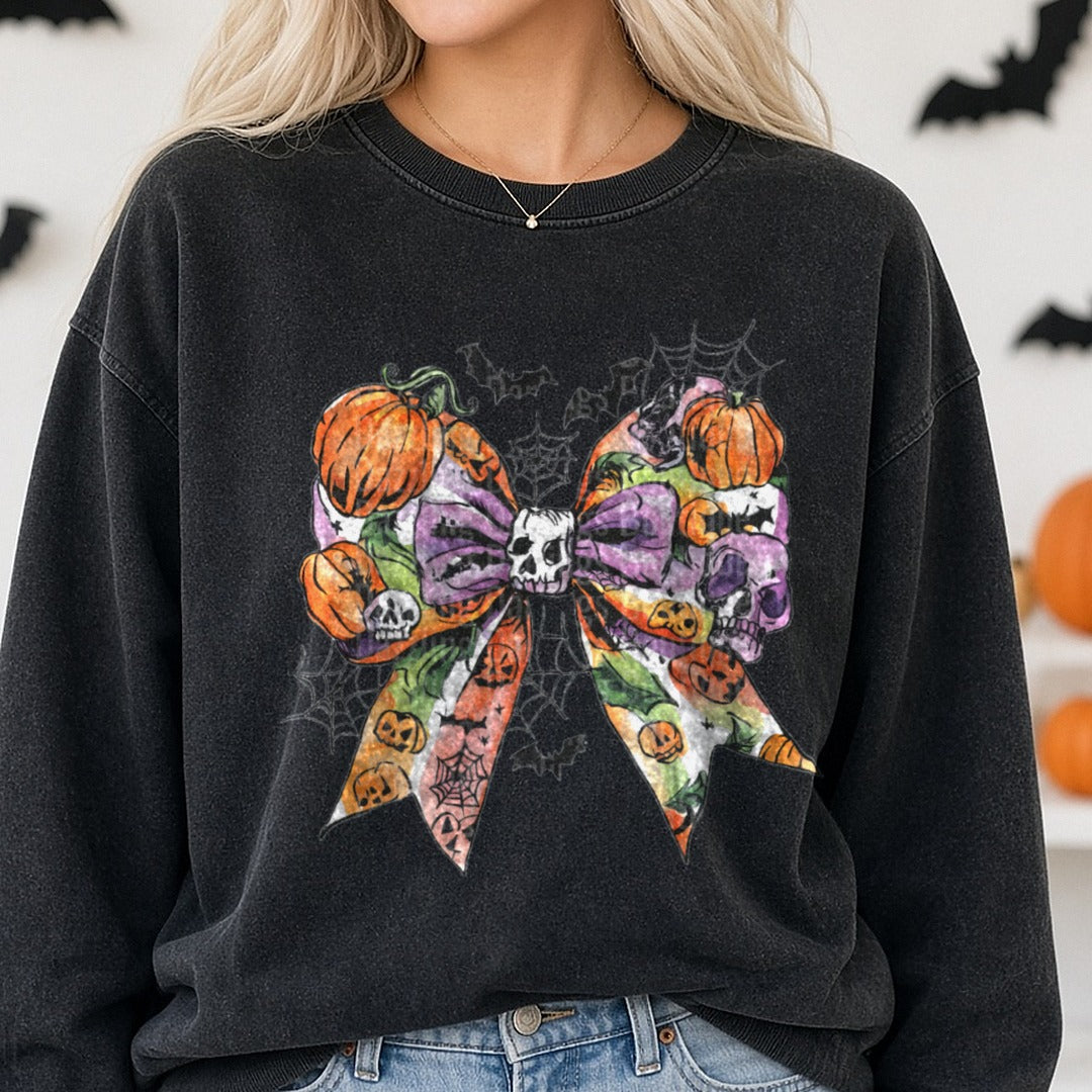 Halloween Fall Coquette Bow Purple Pumpkins Skull Webs DTF transfer shown on a Comfort Colors sweatshirt
