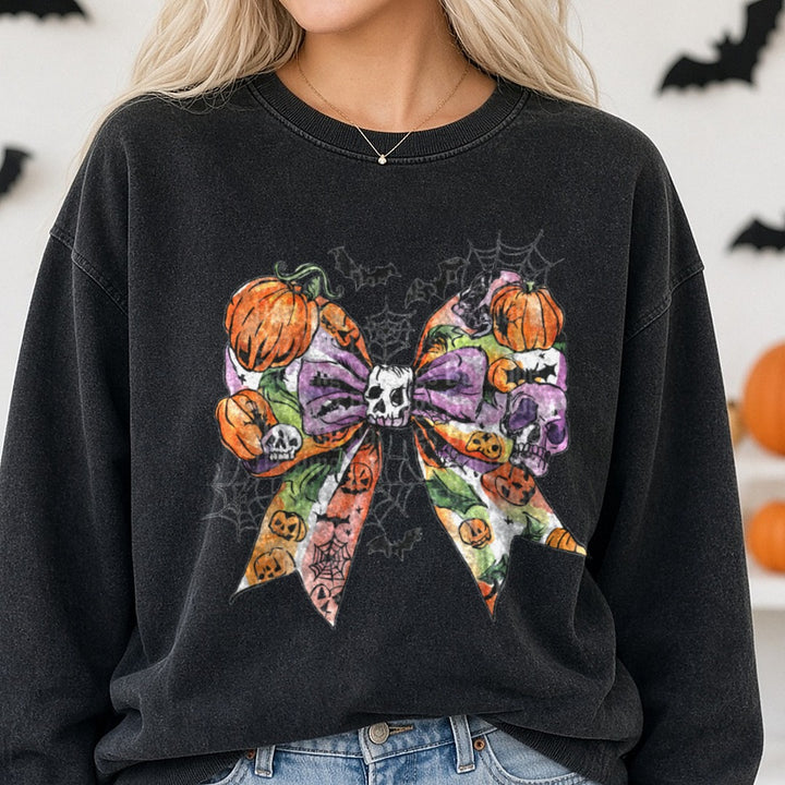 Halloween Fall Coquette Bow Purple Pumpkins Skull Webs DTF transfer shown on a Comfort Colors sweatshirt