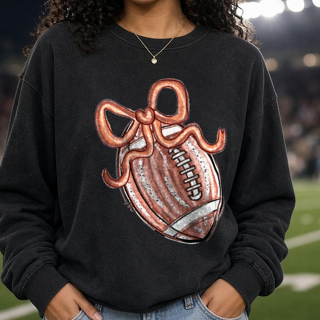 Coquette Football With Copper Bow DTF transfer shown on a Comfort Colors sweatshirt