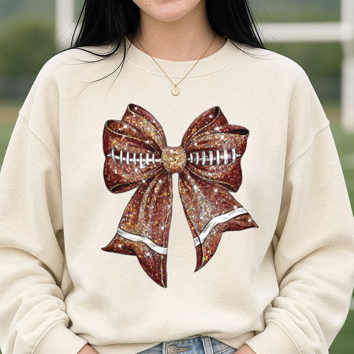 Glitter Football Coquette Bow PNG DTF transfer shown on a Comfort Colors sweatshirt