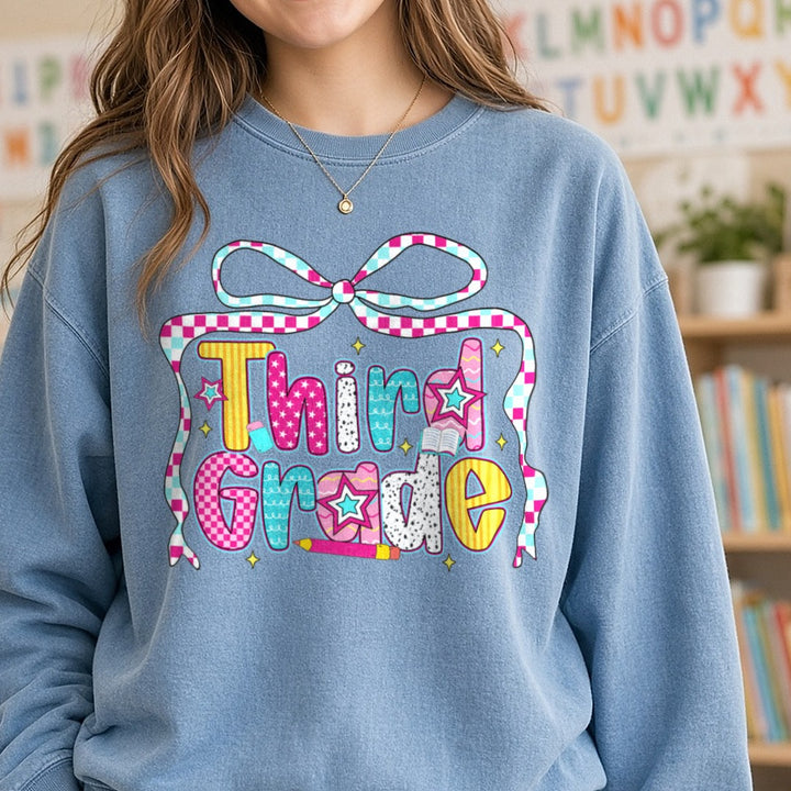 Third Grade Checkered Ribbon Bow Patterned Letters DTF transfer shown on a Comfort Colors sweatshirt