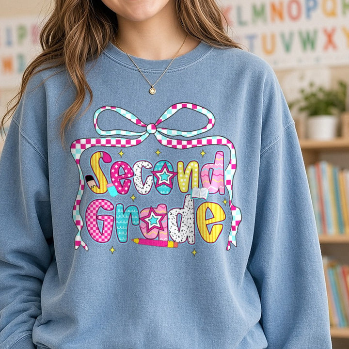 Second Grade Checkered Ribbon Bow Patterned Letters DTF transfer shown on a Comfort Colors sweatshirt