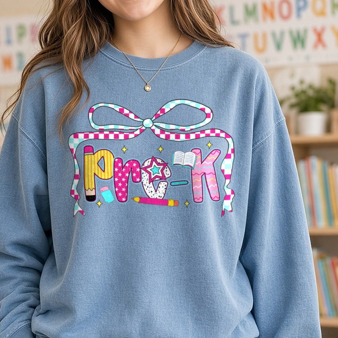 Pre-K Checkered Ribbon Bow Patterned Letters DTF transfer shown on a Comfort Colors sweatshirt