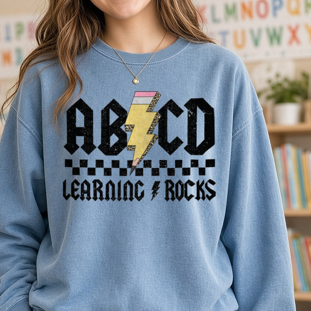 ABCD Learning Rocks DTF transfer shown on a Comfort Colors sweatshirt