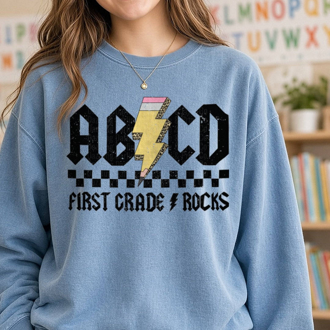 ABCD First Grade Rock DTF transfer shown on a Comfort Colors sweatshirt