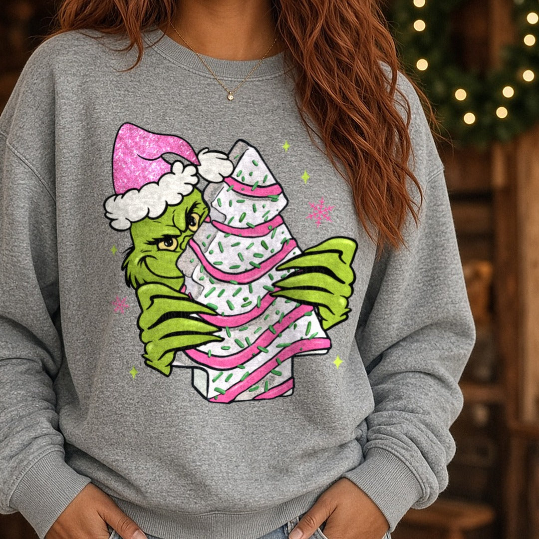 Christmas Tree Cake Green Guy DTF transfer shown on a Comfort Colors sweatshirt
