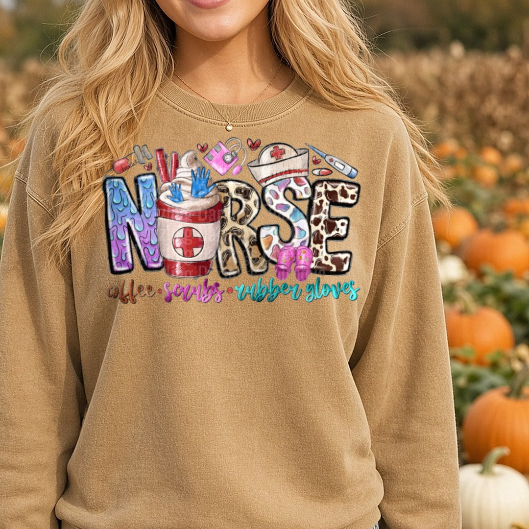Nurse Coffee Scrubs Rubber Gloves Leopard Patterned Letters DTF transfer shown on a Comfort Colors sweatshirt