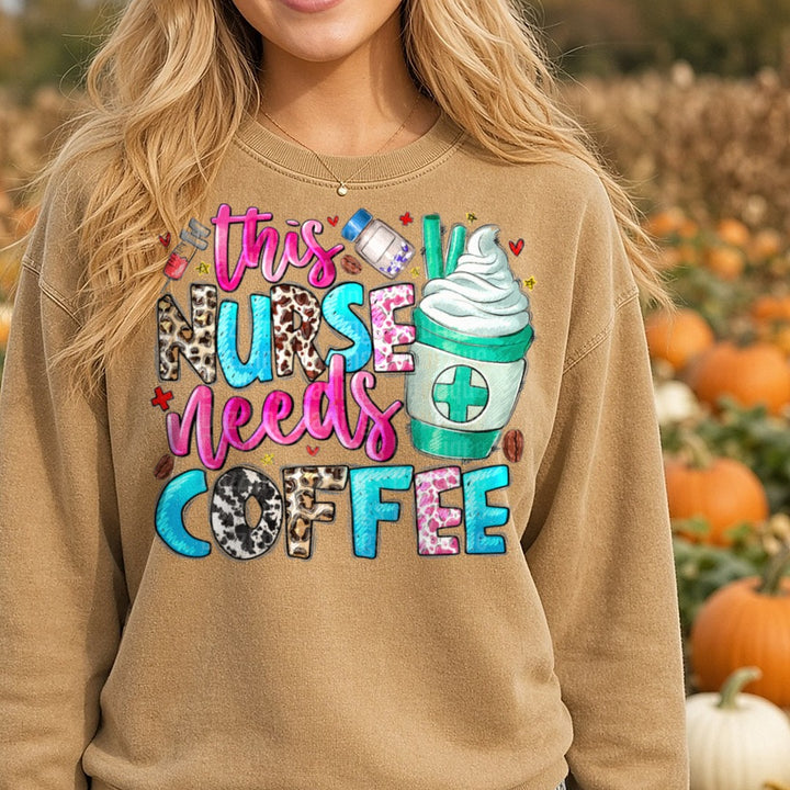 This Nurse Needs Coffee DTF transfer shown on a Comfort Colors sweatshirt