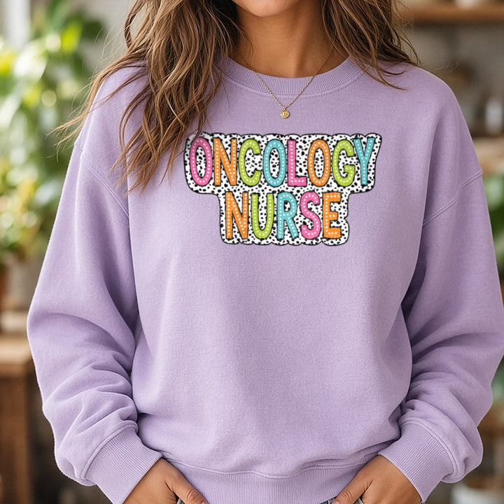 Oncology Nurse Dalmatian Dots DTF transfer shown on a Comfort Colors sweatshirt