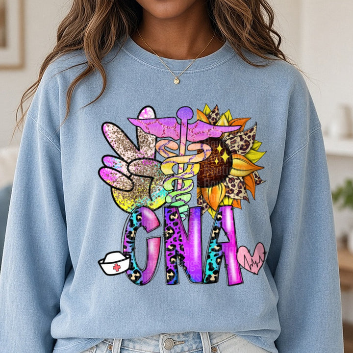CNA Certified Nurse Assistant DTF transfer shown on a Comfort Colors sweatshirt