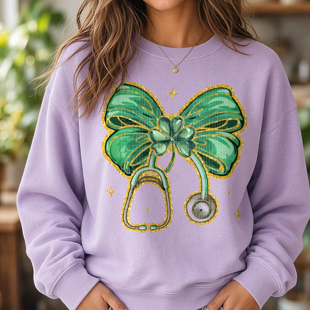 Nurse St. Patty's Day Green Glitter Bow Stethoscope Shamrock DTF transfer shown on a Comfort Colors sweatshirt