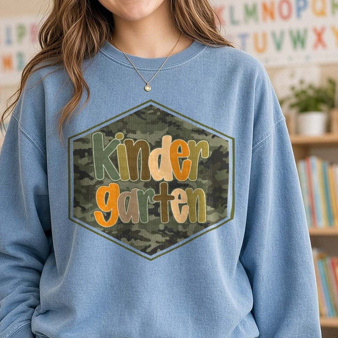 Kindergarten Camo Hexagon Badge Orange Green Letters DTF transfer shown on a Comfort Colors sweatshirt
