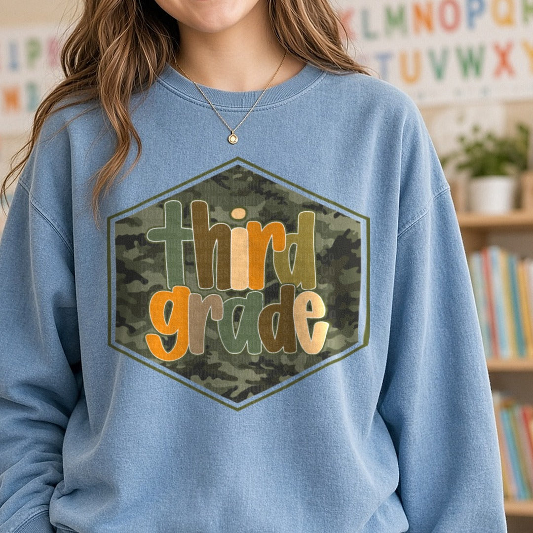 Third Grade Camo Hexagon Badge Orange Green Letters DTF transfer shown on a Comfort Colors sweatshirt