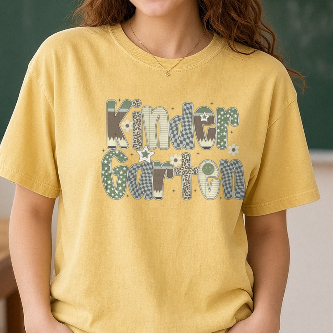 Kindergarten Camo Patterned Letters Stars Leopard DTF transfer shown on a Comfort Colors tee