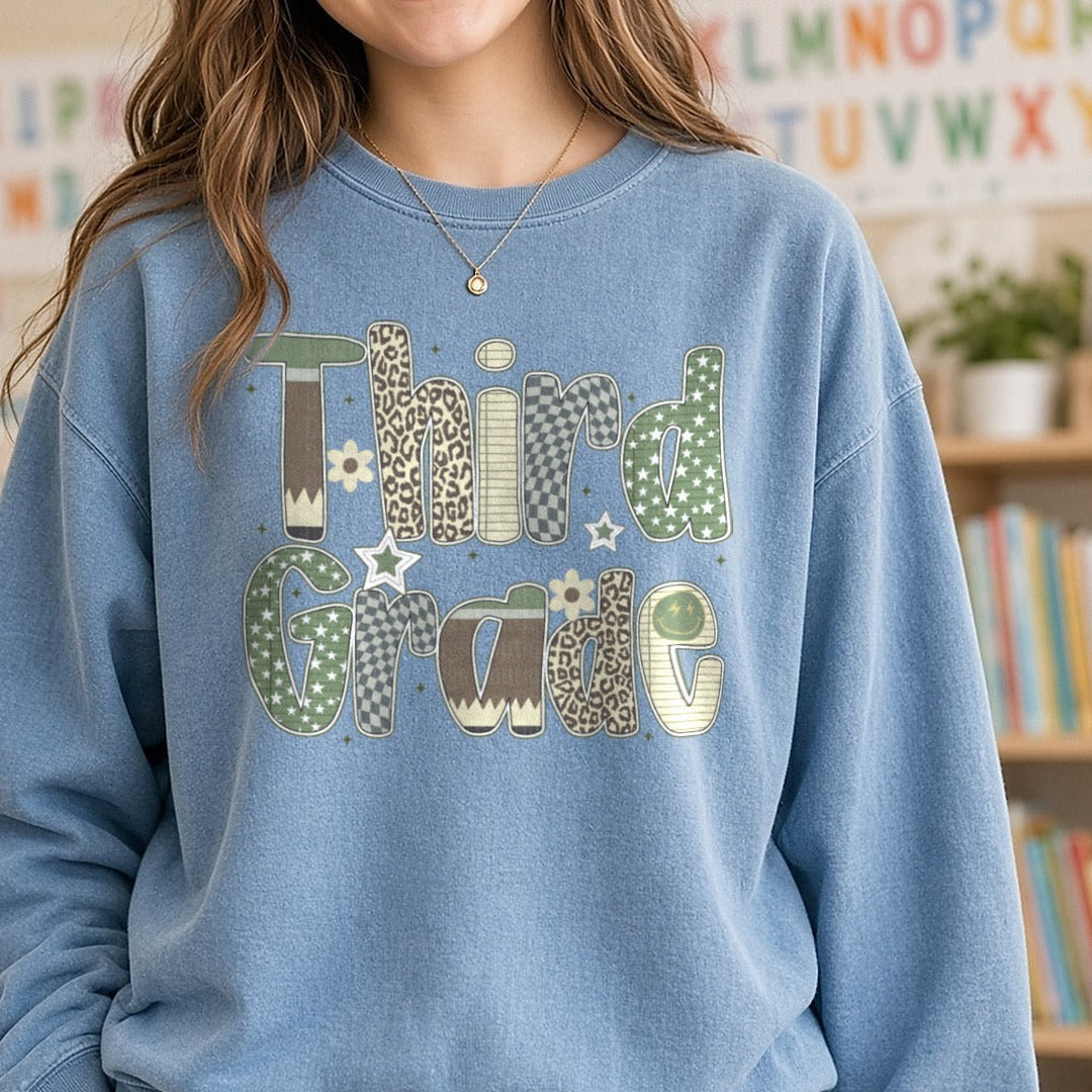 Third Grade Camo Patterned Letters Stars Leopard DTF transfer shown on a Comfort Colors sweatshirt