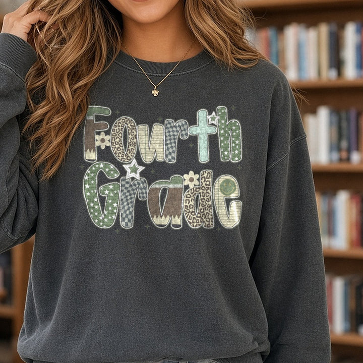 Fourth Grade Camo Patterned Letters Stars Leopard DTF transfer shown on a Comfort Colors sweatshirt