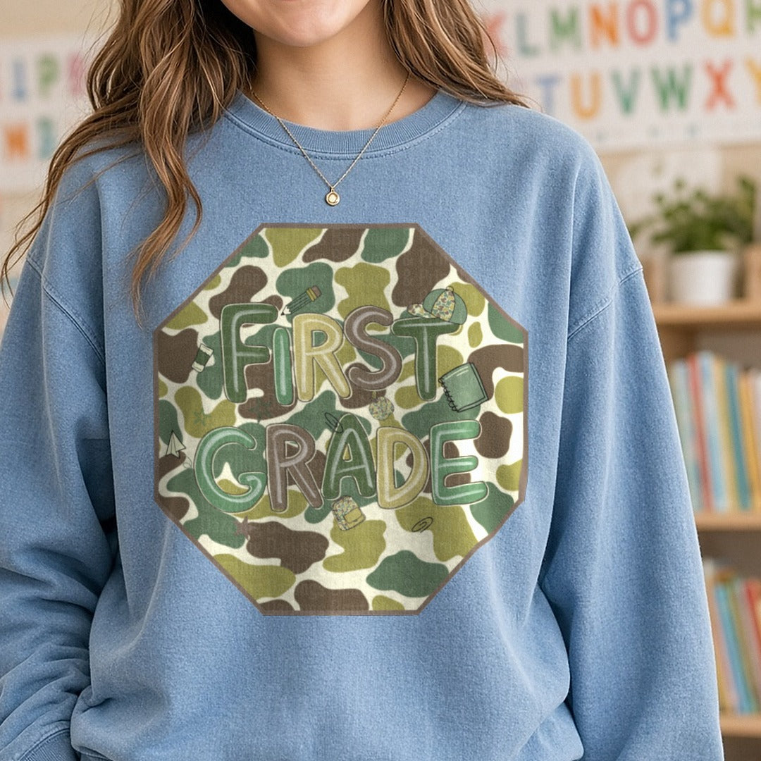 First Grade Camo Octagon Duck Camo Background DTF transfer shown on a Comfort Colors sweatshirt