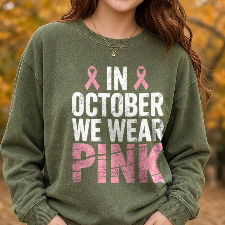 Breast Cancer Awareness Ribbon in October We Wear Pink DTF transfer shown on a Comfort Colors sweatshirt