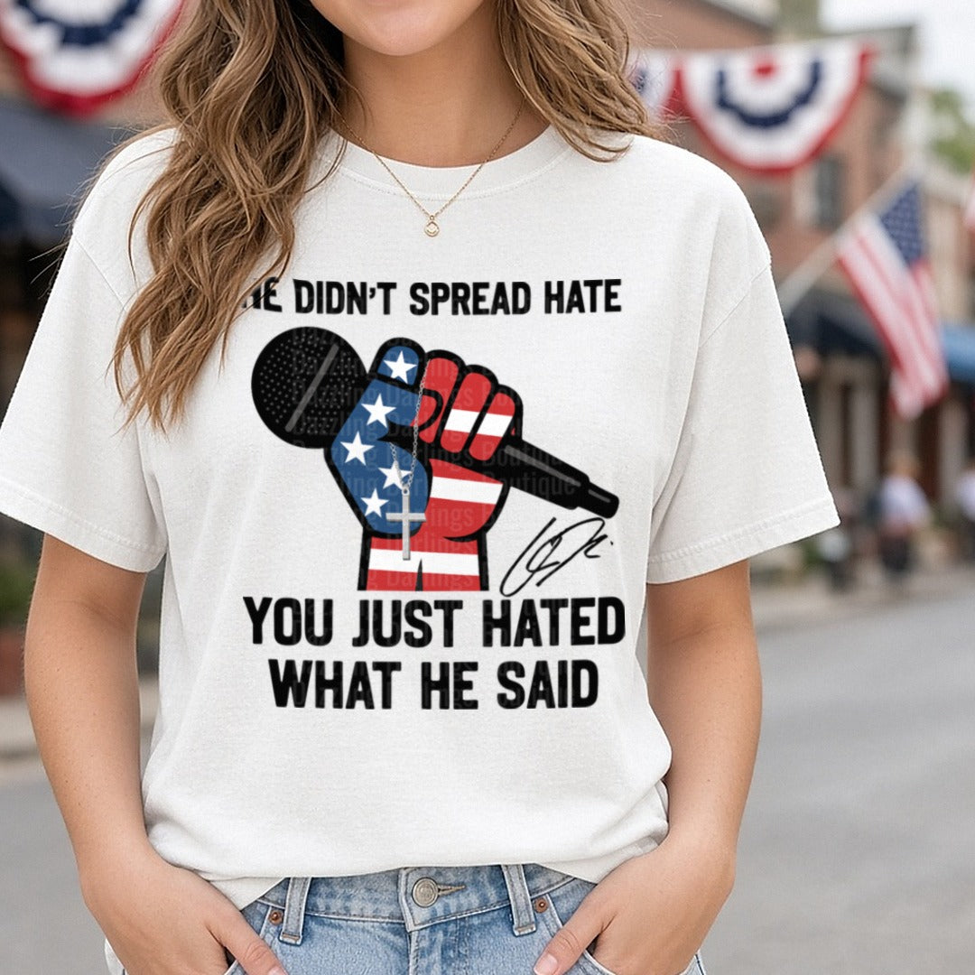 Charlie Kirk He Didn't Spread Hate Flag Fist Microphone DTF transfer shown on a Comfort Colors tee