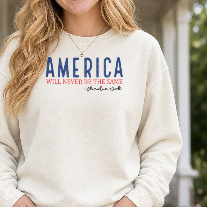 America Will Never Be The Same Charlie Kirk Blue Red DTF transfer shown on a Comfort Colors sweatshirt